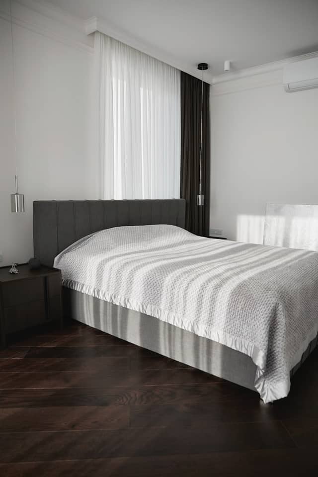 Hardwood floor in a modern bedroom with low furniture